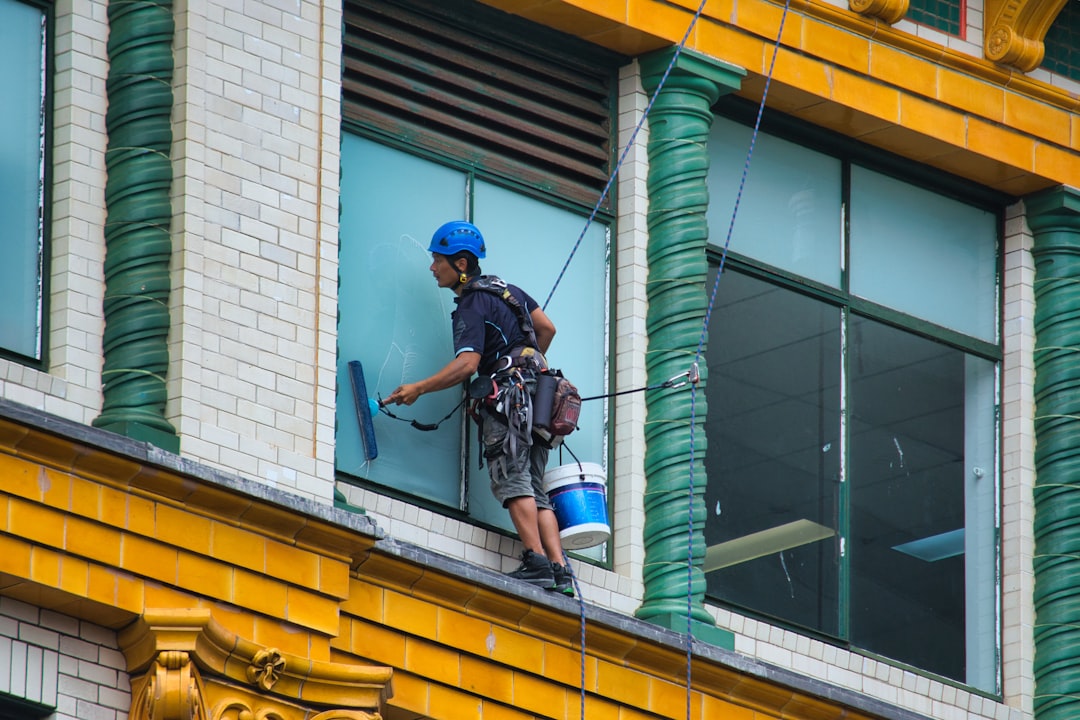 Services-01 A window cleaner cleaning the windows of a building.